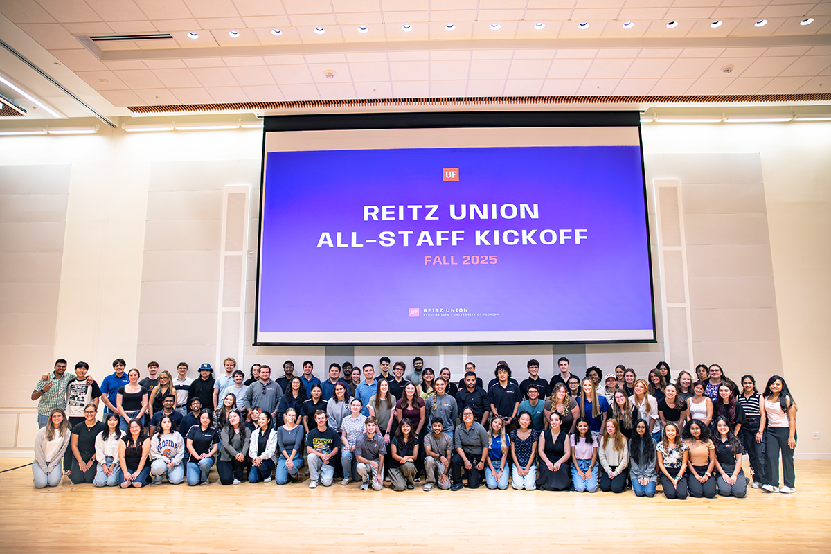 A large group of Reitz Union student employees pose for a group photo at a staff kickoff event.